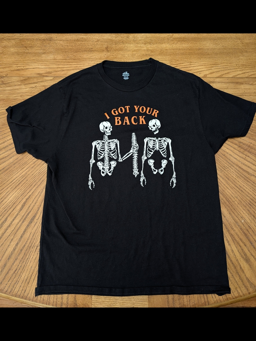 Celebrate HalloweenBlack Skeleton Graphic Tee with Orange 'I Got Your Back' Text